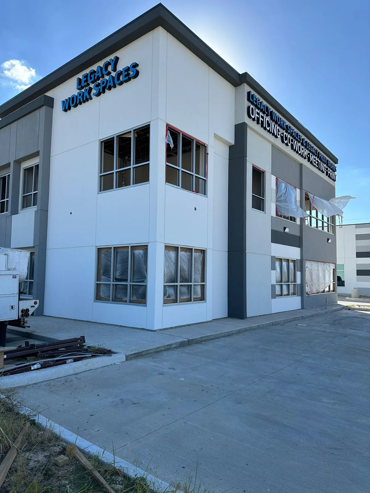 Dimensional letter building signs for Legacy Work Spaces co-working office on a two-story commercial building in Houston, Texas