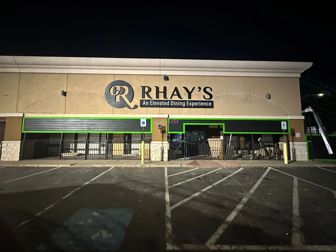 Halo-lit dimensional storefront sign for Rhay's restaurant on a commercial building in Houston, Texas, lit at night