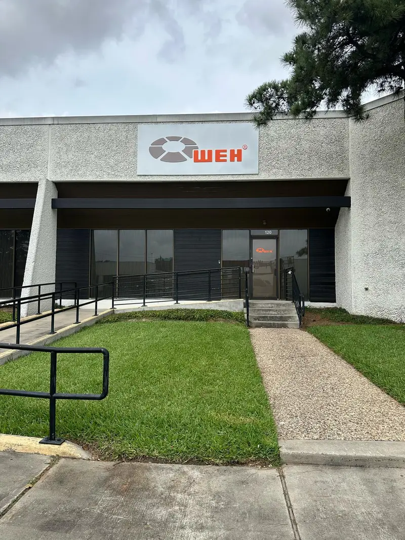 Dimensional logo and letter sign for WEH Technologies on a commercial building facade in Houston, Texas